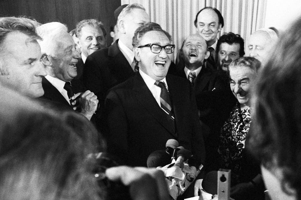 U.S. Secretary of State Henry Kissinger, Israeli Prime Minister Golda Meir, and other Israeli cabinet ministers roar with laughter after she had been kissed by Kissinger at a party May 29th, 1974. *Bettmann/Getty*. Kissing Conversations