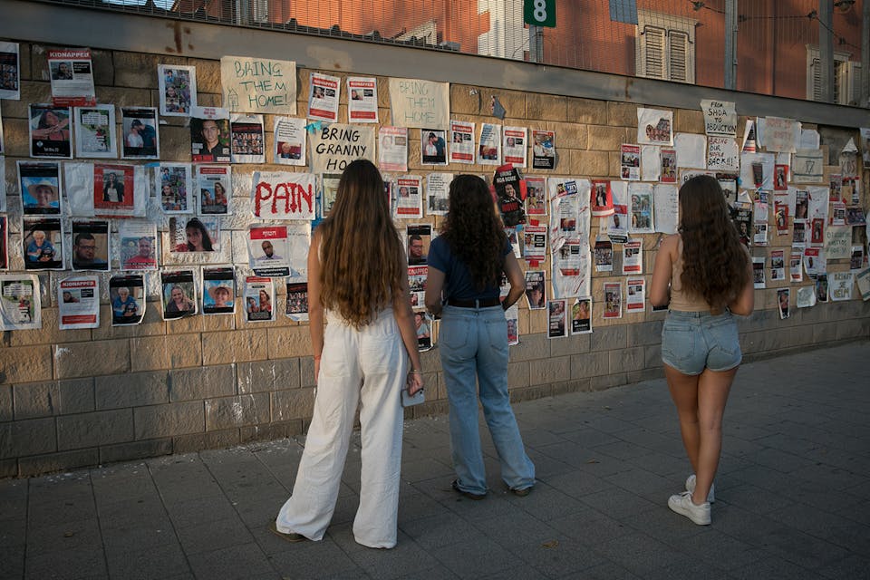 Israelis look at photographs of Israelis held hostage by Hamas terrorists in Tel Aviv, on November 03, 2023. *Miriam Alster/FLASH90*. Philolos Bsorot