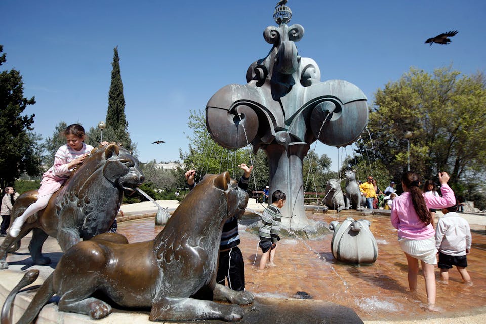Young Jewish children play in a fountain in Jerusalem during Passover on March 31, 2010. *Miriam Alster/FLASH90.* Maghen Yes Main