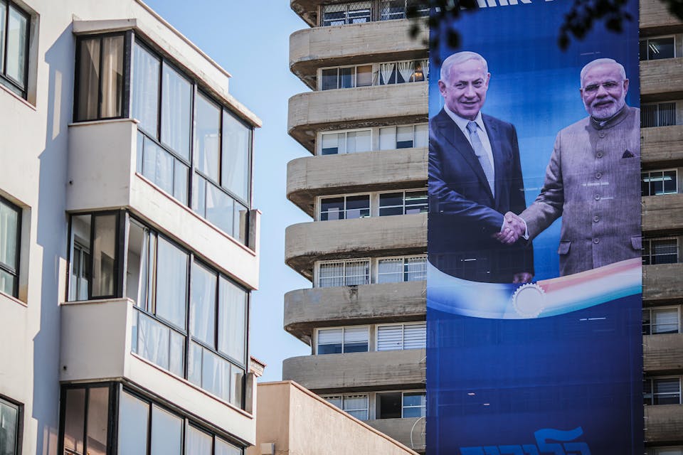 An election campaign banner showing Benjamin Netanyahu shaking hands with Narendra Modi in September 2019. *Ilia Yefimovich/picture alliance via Getty Images*. Israel India Main