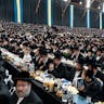 A celebration on the anniversary of the escape from Hungary in 1944 of Rabbi Joel Teitelbaum, the first Satmar *rebbe*. *Lev Radin/Pacific Press/LightRocket via Getty Images.* Spitzer Satmar