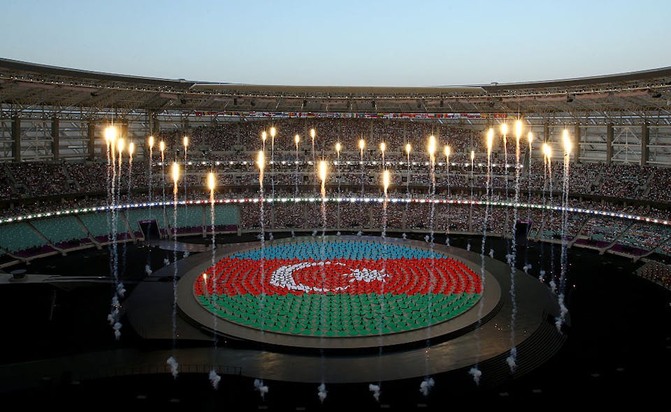 BAKU, AZERBAIJAN – JUNE 12:  Performers depict the national flag of Azerbaijan during the Opening Ceremony for the Baku 2015 European Games at the Olympic Stadium on June 12, 2015 in Baku, Azerbaijan.  (Photo by Richard Heathcote/Getty Images for BEGOC)