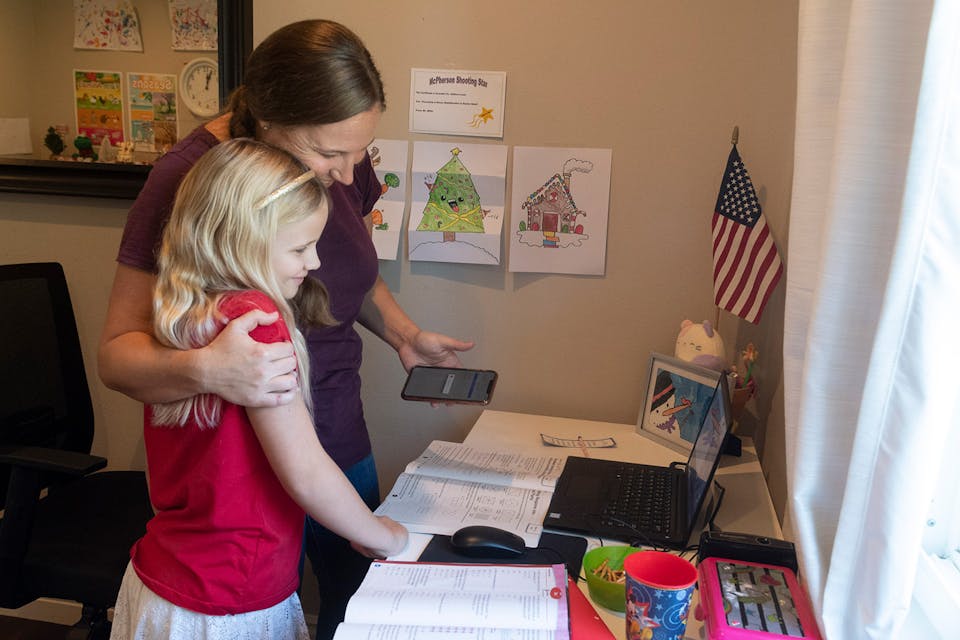 A mother gives a hug to her third-grade daughter during at-home learning in Orange, CA on Wednesday, December 9, 2020. *Paul Bersebach/MediaNews Group/Orange County Register via Getty Images*. Smarick Main