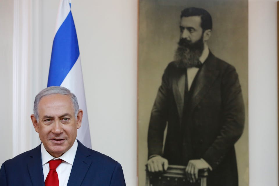 Benjamin Netanyahu by a portrait of Theodor Herzl on May 2, 2018. *ABIR SULTAN/POOL/AFP via Getty Images*. Netanyahu Main