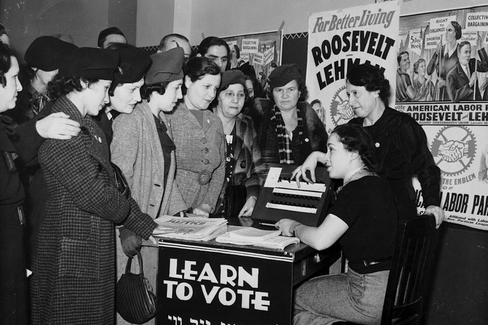 Women surrounded by posters in English and Yiddish supporting Franklin D. Roosevelt teach other women how to vote in 1935. *International Ladies Garment Workers Union Photographs (1885-1985), Kheel Center for Labor-Management Documentation and Archives, Cornell University Library.* Women_voter_outreach_1935_English_Yiddish