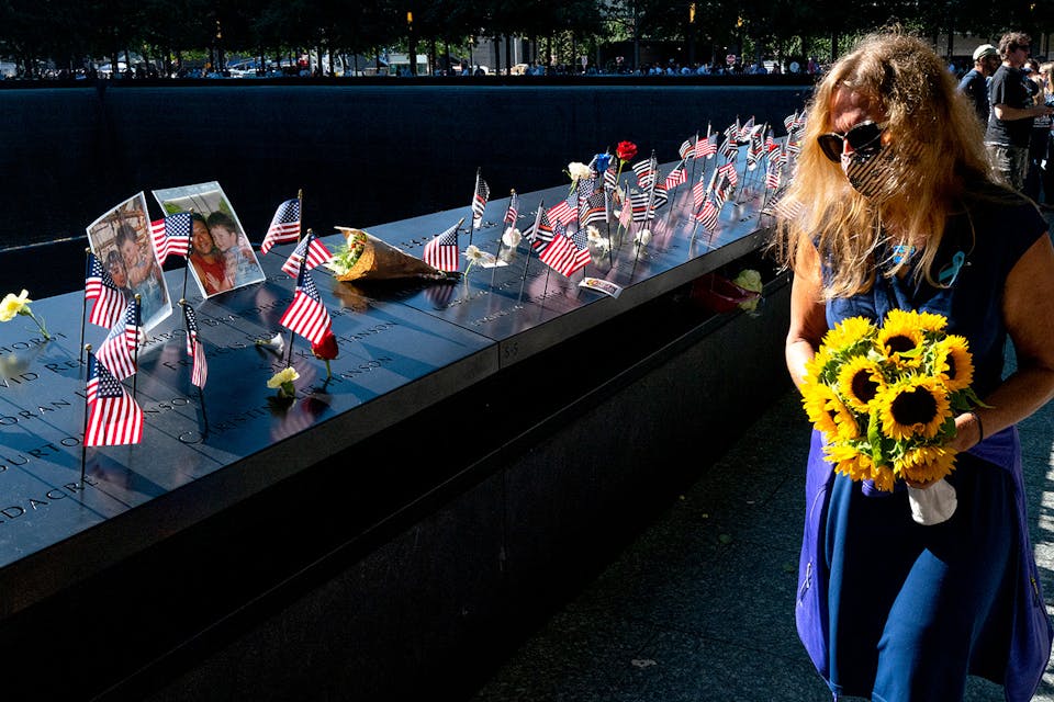 Flags and flowers adorn the names of the victims of the attacks during a ceremony at the 9/11 Memorial and Museum on September 11, 2021 in New York City. *Craig Ruttle-Pool/Getty Images.* McClay 911