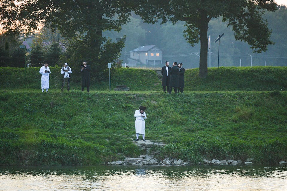 Orthodox Jews praying on the last day of Rosh Hashanah on the bank of the San river in Dynow, Poland on Sunday, September 20, 2020. *Artur Widak/NurPhoto via Getty Images*. Philologos UT Main