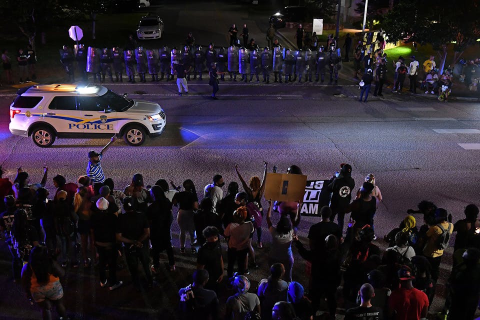 Police officers stand guard during a protest against police brutality in Rock Hill, South Carolina on June 24, 2021. *Peter Zay/Anadolu Agency via Getty Images*. Berkowitz Taub Main