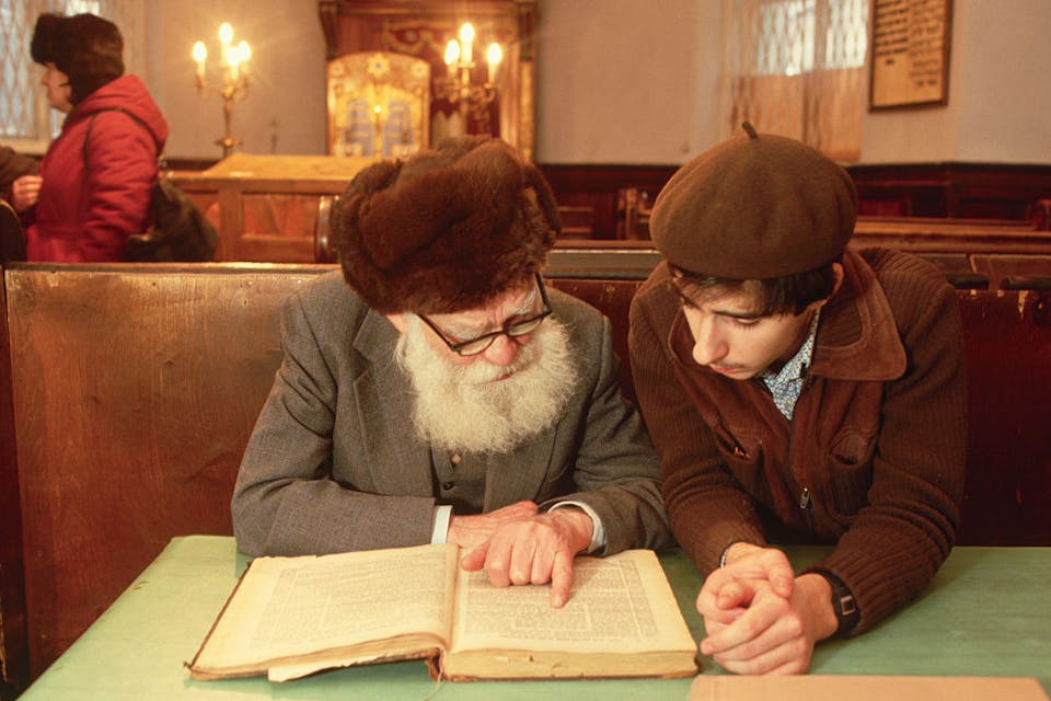 A young man studies with an older one in a Moscow synagogue. *Photo by Peter Turnley/Corbis/VCG via Getty Images.* A young man studies with an old man in a synagogue on Arkhipova Street in Moscow. (Photo by Peter Turnley/Corbis/VCG via Getty Images)
