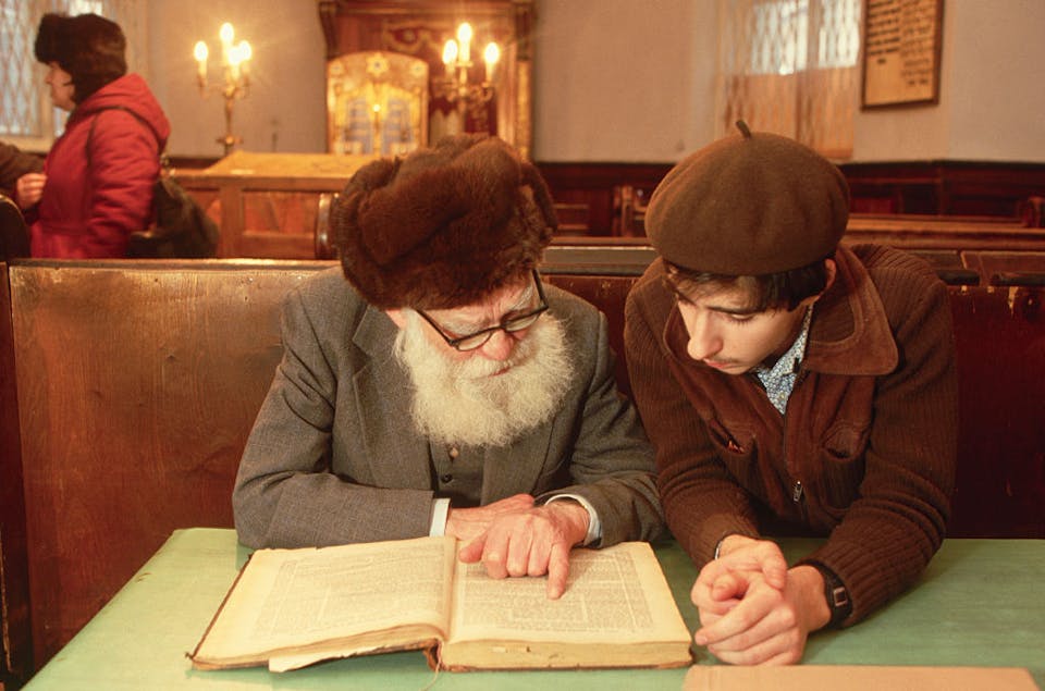 A young man studies with an old man in a synagogue on Arkhipova Street in Moscow.   (Photo by Peter Turnley/Corbis/VCG via Getty Images)