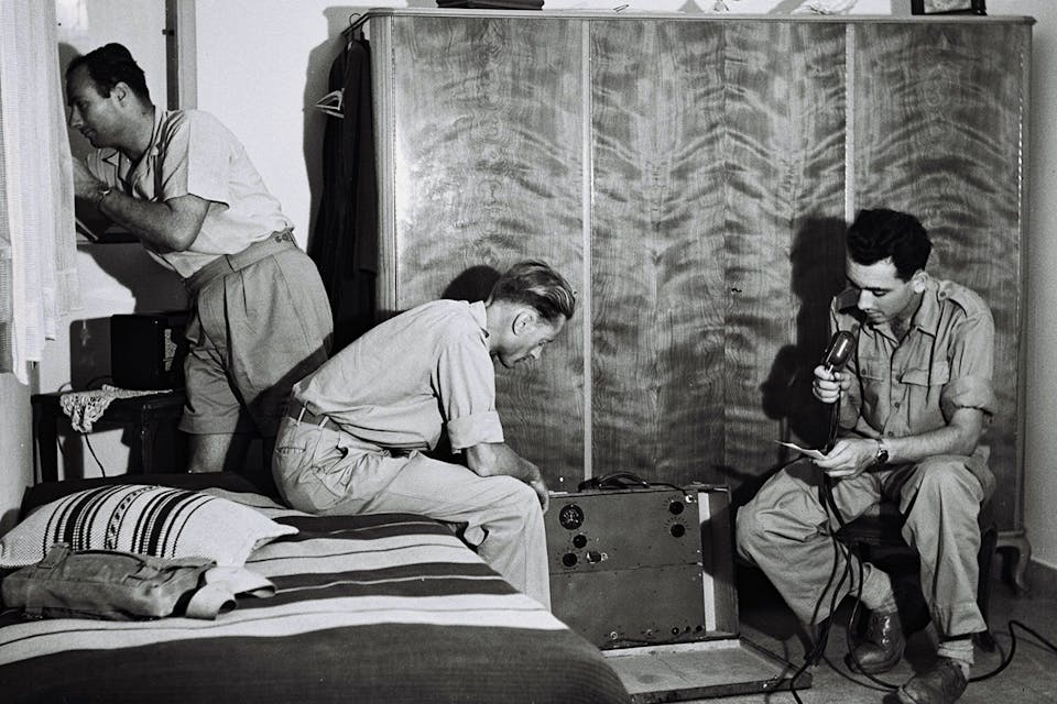 Jewish fighters at their radio in an undisclosed hideout on April 10, 1948, in the weeks before the founding of the state of Israel. *Zoltan Kluger/GPO via Getty Images*. Kramer Independence 2