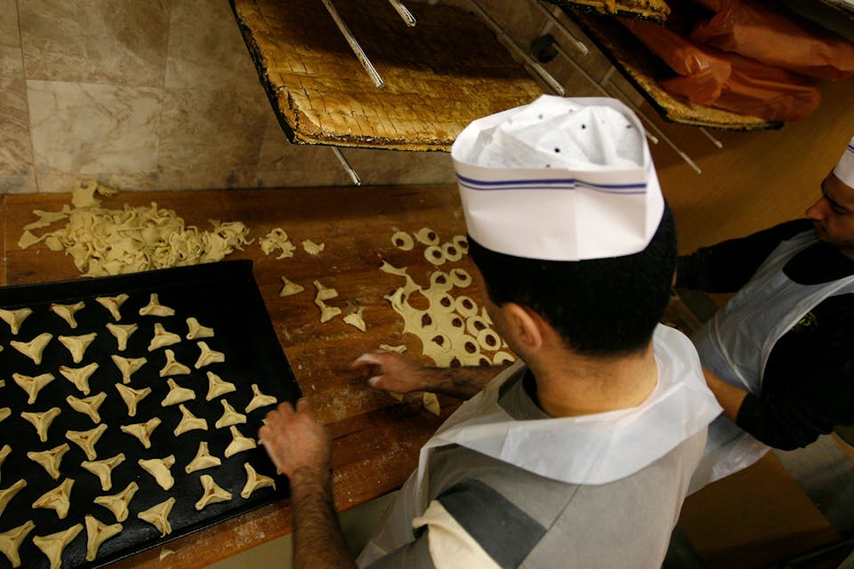 Bakers in Jerusalem make hamantaschen for Purim in 2009. *Miriam Alster/Flash90*. Schulmann Main
