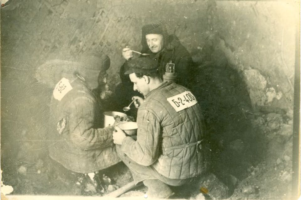 Political prisoners eating lunch in a gulag coal mine. *Wikipedia*. 2064101_Museu_ProvidedCHO_Kauno_IX_forto_muziejus___Kaunas_9th_Fort_Museum_LIMIS_60000003528378