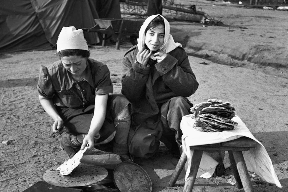 Women cooking flatbread at the liberated Bergen-Belsen concentration camp in 1945.* George Rodger/The LIFE Picture Collection via Getty Images.* Rosenfarb Main