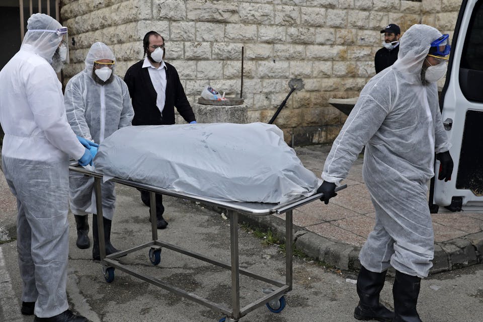 *Israeli workers transporting the body of a patient who died from complications of coronavirus in Jerusalem on April 1, 2020.* AHMAD GHARABLI/AFP via Getty Images. Brody Corona Main