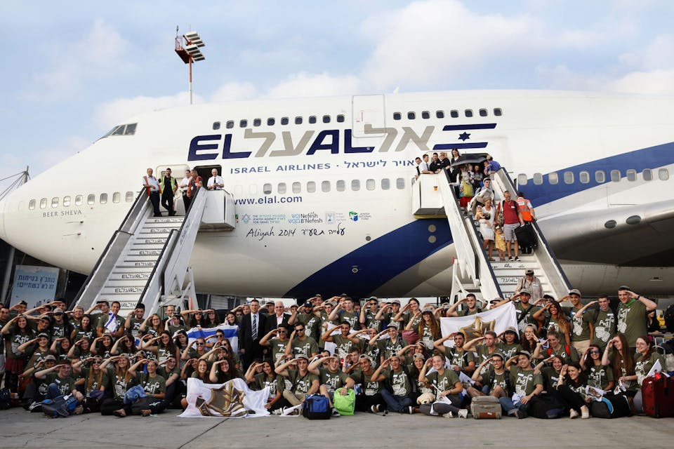 *Israeli President Reuven Rivlin and Interior Minister Gideon Saar (C-L) pose at Ben Gurion Airport with new immigrants to Israel on August 12, 2014.* GALI TIBBON/AFP via Getty Images. Lieberman Main