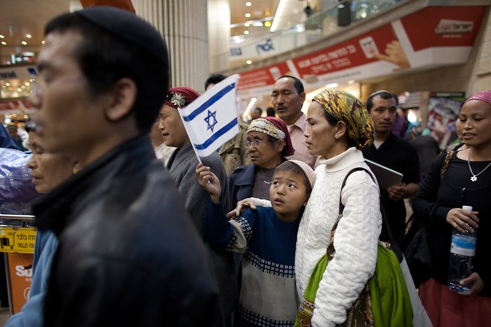 *Members of the B'nei Menashe community reunite with relatives at Israel's Ben-Gurion airport on December 24, 2012.* Uriel Sinai/Getty Images. Bnei Menashe Main