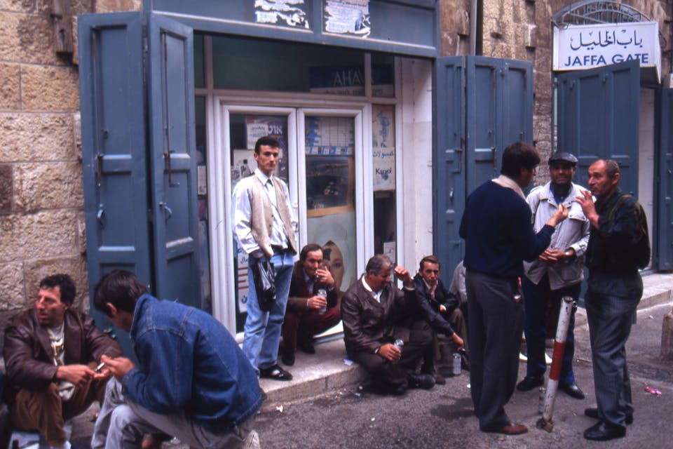 *Customers smoke and talk in front of a shop in Jerusalem in 1970*. Angelo Cozzi/Archivio Angelo Cozzi/Mondadori Portfolio via Getty Images. Wisse Jerusalem Main