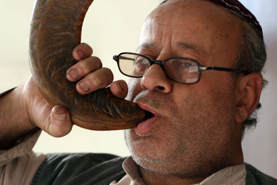 *Afghanistan's only known Jew, Zebulon Simantov, blowing a shofar in his home in Kabul.* Getty Images. Shofar