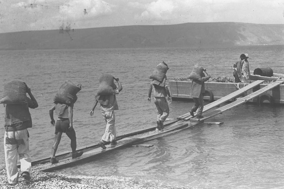 *Men build the breakwater of a fishing port on the eastern shore of the Sea of Galilee in the early 20th century.* Zoltan Kluger/Government Press Office. 7724379038_7e42647da4_k