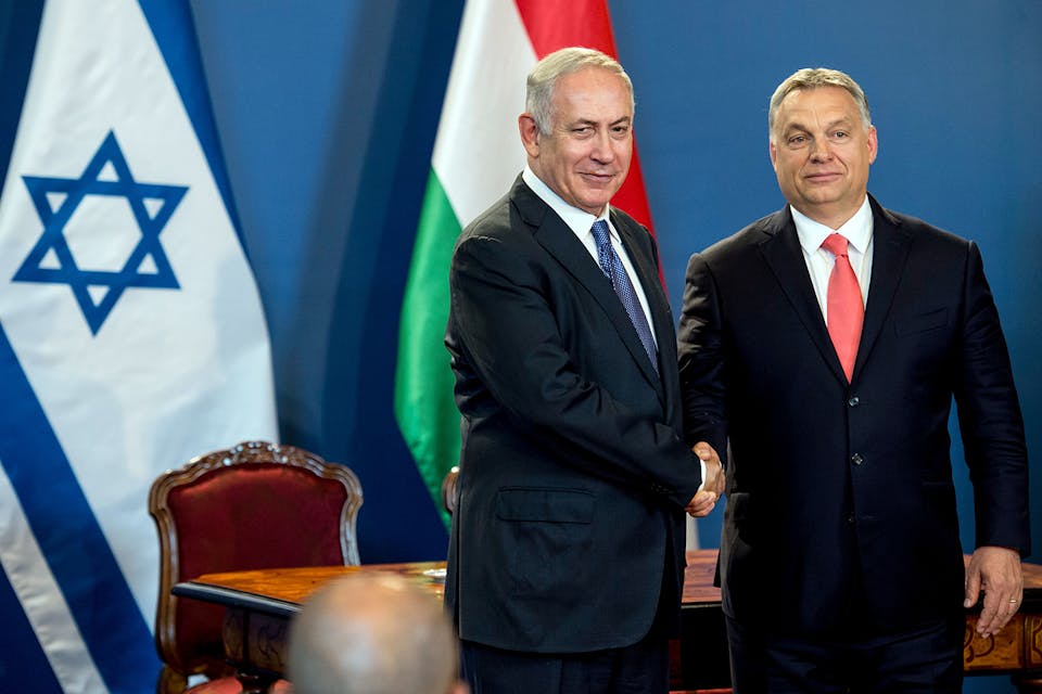 *Israeli Prime Minister Benjamin Netanyahu and his Hungarian counterpart Viktor Orbán shake hands as they give a joint press conference at the parliament in Budapest, Hungary, on July 18, 2017.* KAROLY ARVAI/AFP/Getty Images. Orban