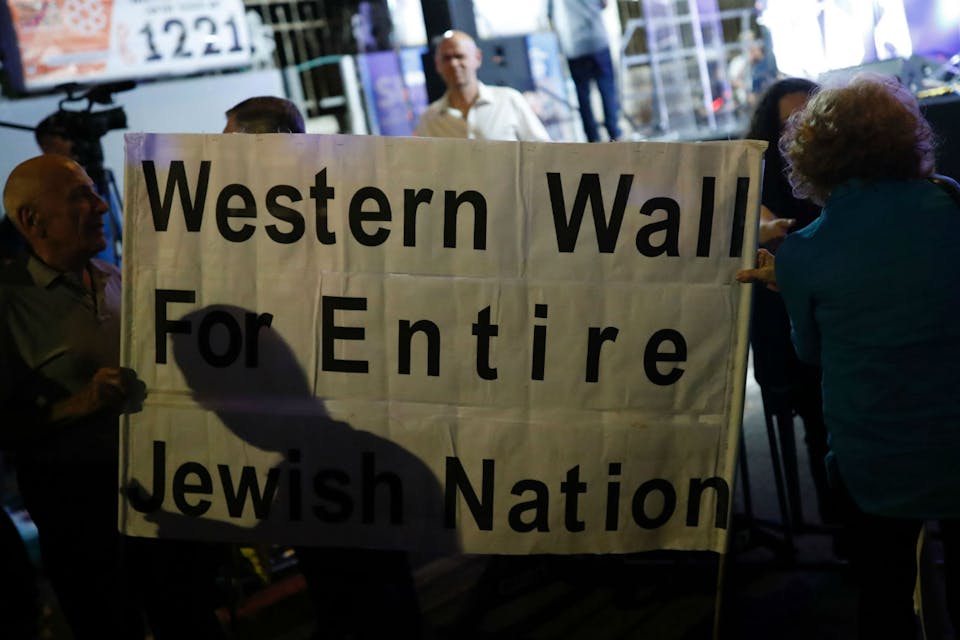 *Israelis gather outside prime minister Benjamin Netanyahu's residence in Jerusalem on July 1, 2017, to demonstrate against a government decision to abandon a deal to allow women and men to pray together at the Western Wall.* THOMAS COEX/AFP/Getty Images. Gordis Abrams