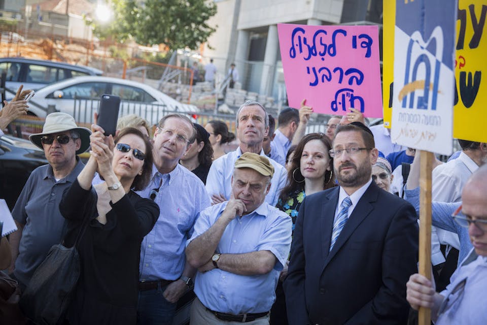 *Jewish Agency Chairman Natan Sharansky, center, in brown cap, and Knesset member Dov Lipman, in jacket and tie at right, at a protest held by American and Israeli Orthodox and Conservative Jews outside the Chief Rabbinate offices in Jerusalem, July 6, 2016.* Hadas Parush/Flash90. Knesset Member Dov Lipman and Jewish Agency Chairman Natan Sharansky participate in a protest held by American and Israeli Orthodox and Conservative Jews outside the Chief Rabbinate offices in Jerusalem, against the Rabbinate’s disqualification of American rabbis’ conversions, on July 6, 2016. The protest was held in response to the Israeli Chief Rabbinate’s rejection of an American woman’s conversion approved by well known American Rabbi Heskel Lookstein, the Yeshuron Community Rabbi in New York and senior Orthodox Rabbi in the United States. Photo by Hadas Parush/Flash90