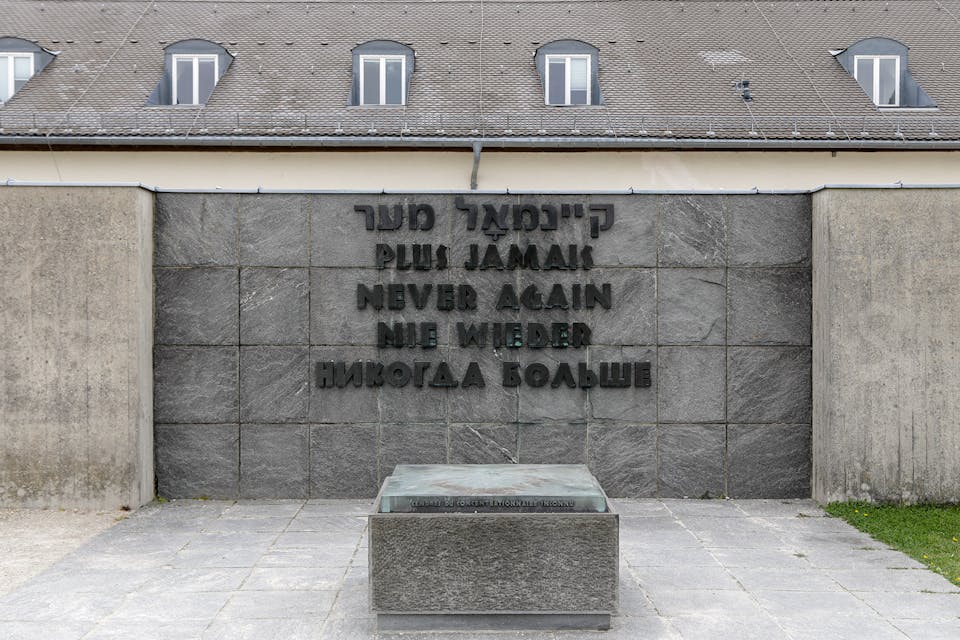 *A memorial at Dachau concentration camp, now a museum.* Athanasios Gioumpasis/Getty Images. never-again
