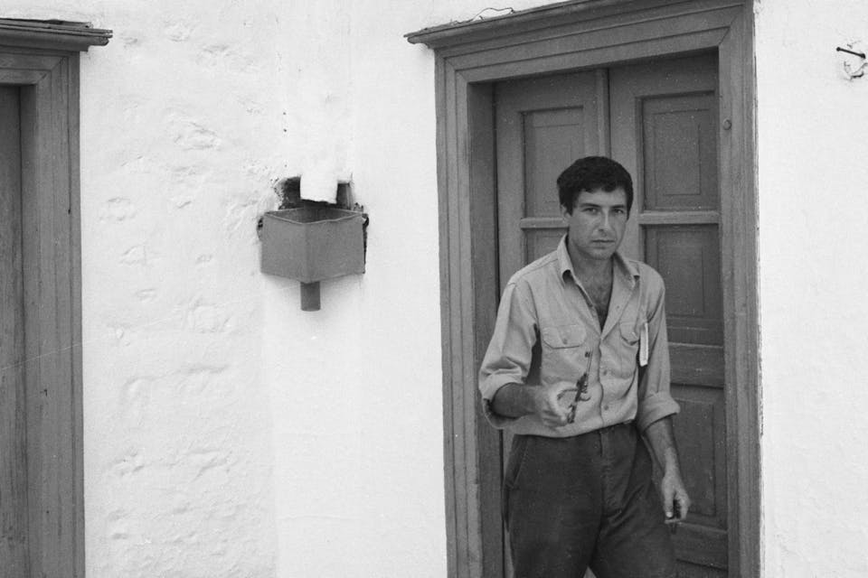 *Leonard Cohen walking on a street near his vacation home in Hydra, Greece, October 1960.* James Burke/The LIFE Picture Collection/Getty Images. Cohen-4