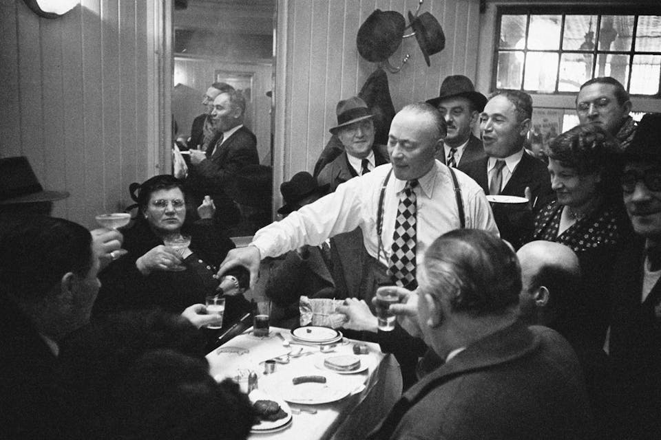 *A Jewish man shares a bottle of champagne with friends in Whitechapel, then the center of the Jewish community in London, April 1952.* Photo by John Chillingworth/Picture Post/Hulton Archive/Getty Images. Toasting-Jews-Main