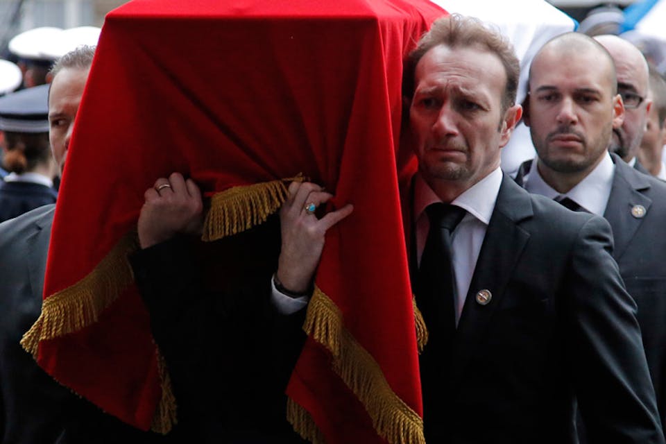 *Mourners carry the coffin of Franck Brinsolaro, one of two French police officers killed in the attack on *Charlie Hebdo. AP Photo/Francois Mori. Funeral-List-Main
