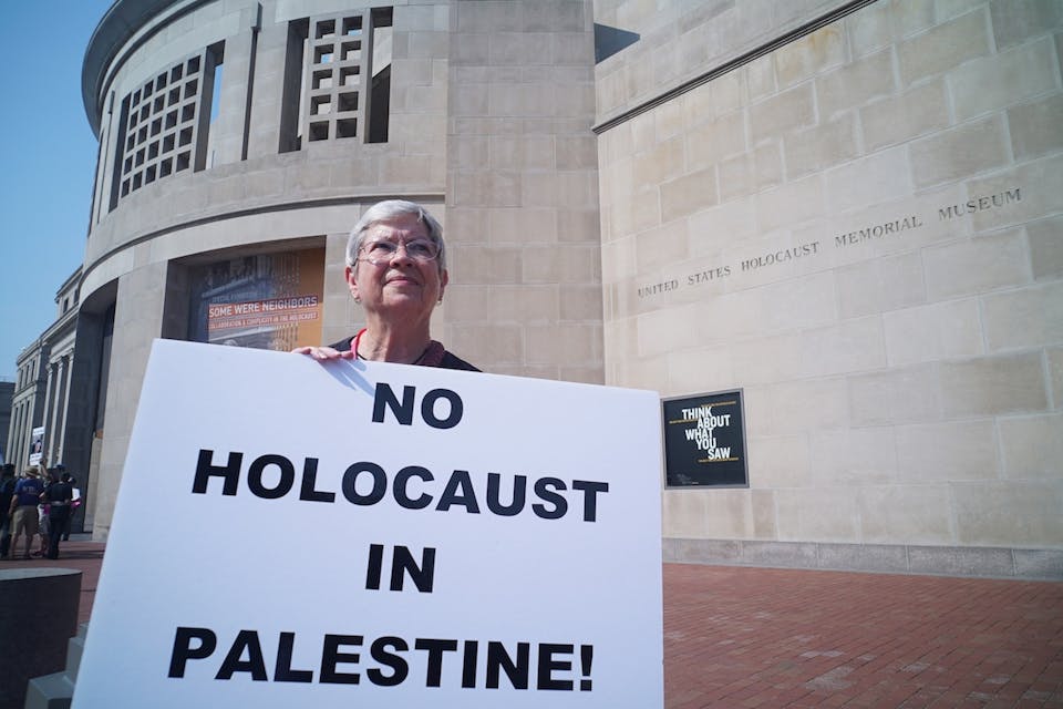 *A woman demonstrating against Israeli action in Gaza outside of the Holocaust Museum in Washington, DC.* Photo by MANDEL NGAN/AFP/Getty Images. noholocaustinpalestinesmall