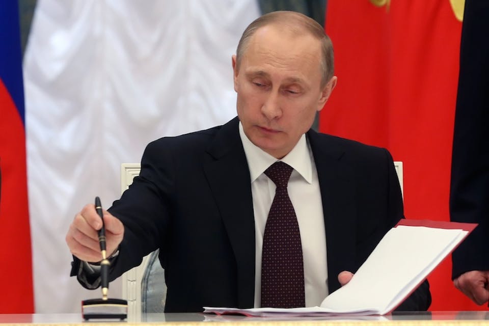 *Russian President Vladimir Putin signs bills making Crimea part of Russia, Friday, March 21, 2014.* Photo credit: AP/Sergei Chirikov. ap166932582905