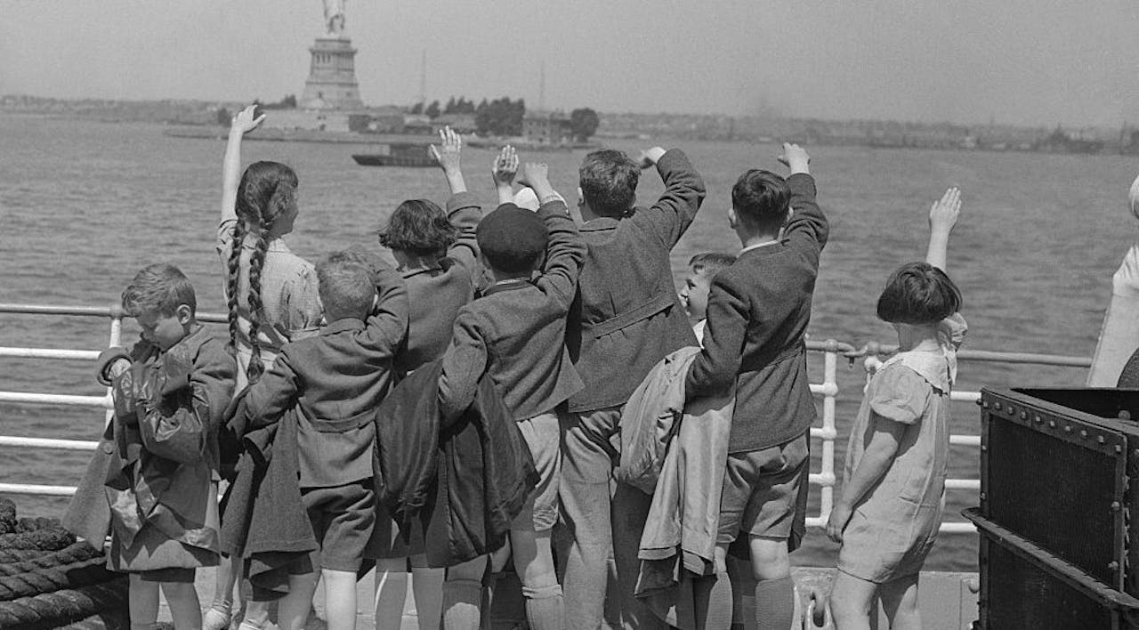 Jewish immigrant children from Austria wave to the Statue of Liberty on their way to New York Harbor. *Bettman, via Getty Images*. 515164532