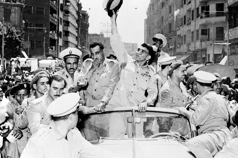 General Mohammed Naguib, center, and Gamal Abdel Nasser, left, ride through Cairo in a cavalcade celebrating Egypt's change from a monarchy to a republic on June 20, 1953. *Keystone/Hulton Archive/Getty Images.* Arab Nationalism Main