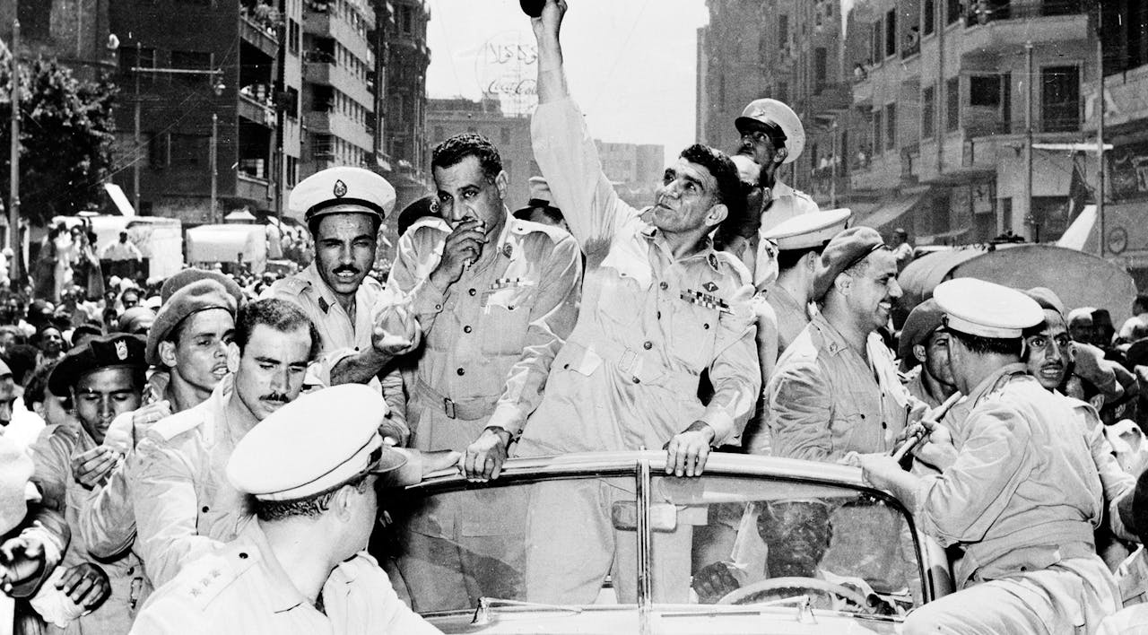 General Mohammed Naguib, center, and Gamal Abdel Nasser, left, ride through Cairo in a cavalcade celebrating Egypt's change from a monarchy to a republic on June 20, 1953. *Keystone/Hulton Archive/Getty Images.* Arab Nationalism Main
