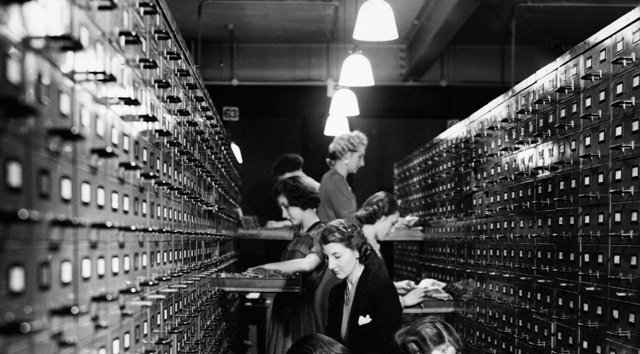 Government workers file index cards for the issue of defense bonds by the National Savings Branch Money Order Department of the General Post Office in 1939. *Hulton-Deutsch/Hulton-Deutsch Collection/Corbis via Getty Images*. Adam White Main