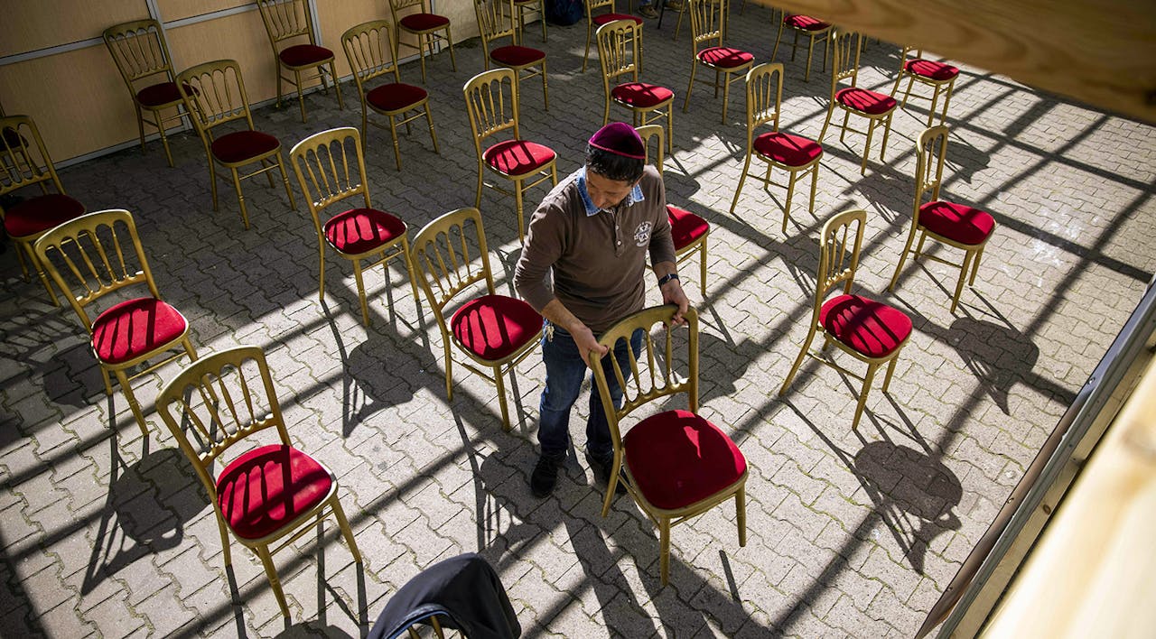 A man setting up for outdoor services on September 18, 2020. *ODD ANDERSEN/AFP via Getty Images*. Wertheimer COVID Main