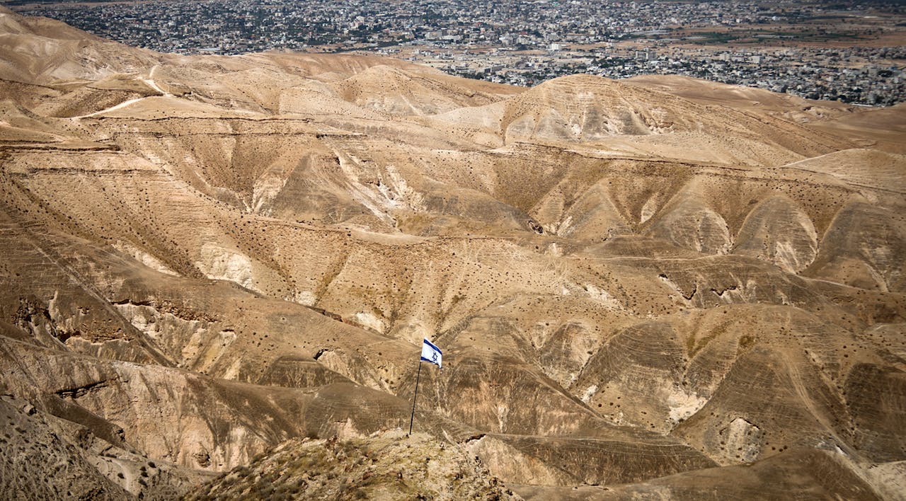 *An Israeli flag with a view of the Jordan Valley in the West Bank on June 14, 2020.* Yonatan Sindel/Flash90. Annexation Main