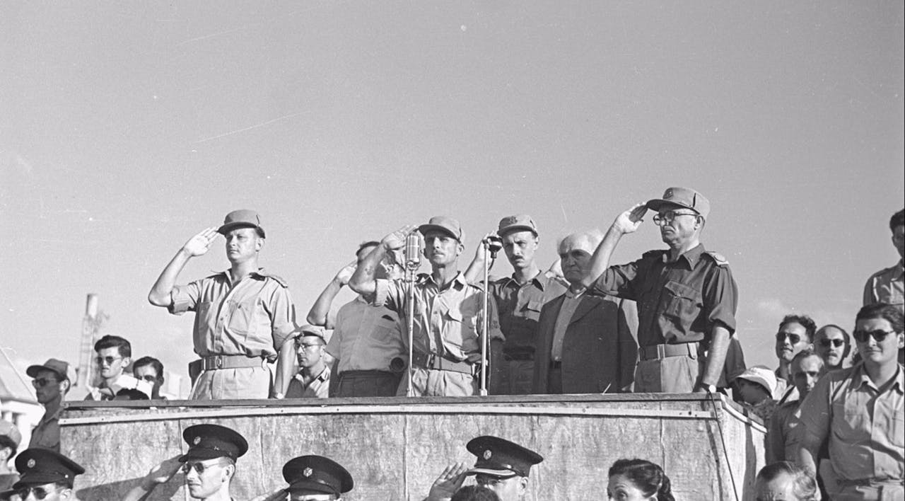 *Maj-Gen. Yigal Allon, Lt-Col. Shimon Avidan, Maj-Gen. Yigael Yadin, David Ben-Gurion, and Lt-Gen. Yaakov Dori reviewing the Givati Brigade in 1948.* Fred Chesnick, IDF Archive. whatsapp-image-2018-05-07-at-103836-am