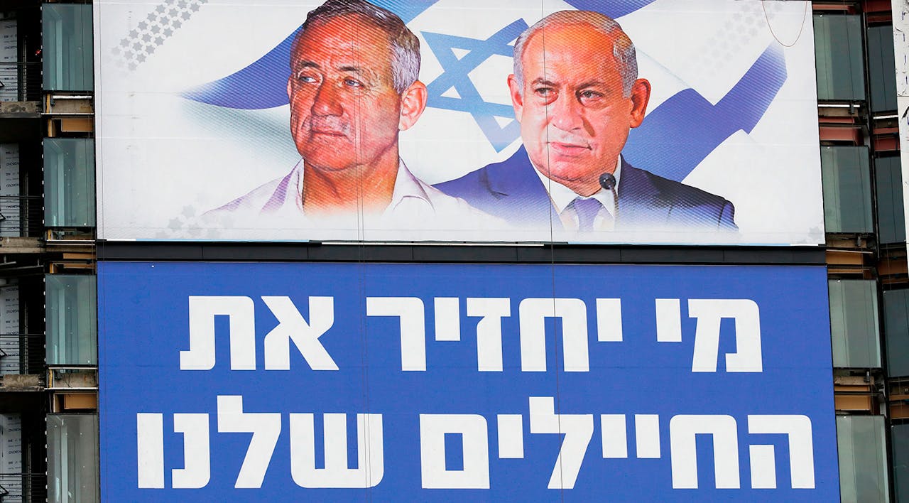 *Benny Gantz and Benjamin Netanyahu on an election billboard in Tel Aviv in March 2019. The Hebrew reads "Who will bring back our soldiers?"* JACK GUEZ/AFP/Getty Images. Gantz Netanyahu Main