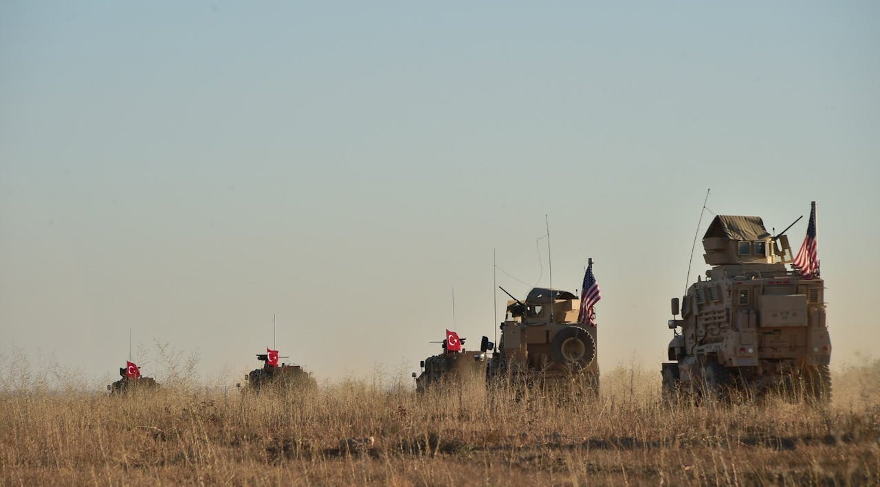 *Turkish and American armored vehicles troops on joint patrol in the northern Syrian city of Manbij on November 1, 2018. *Anadolu Agency/Getty Images. US Syria Doran Main