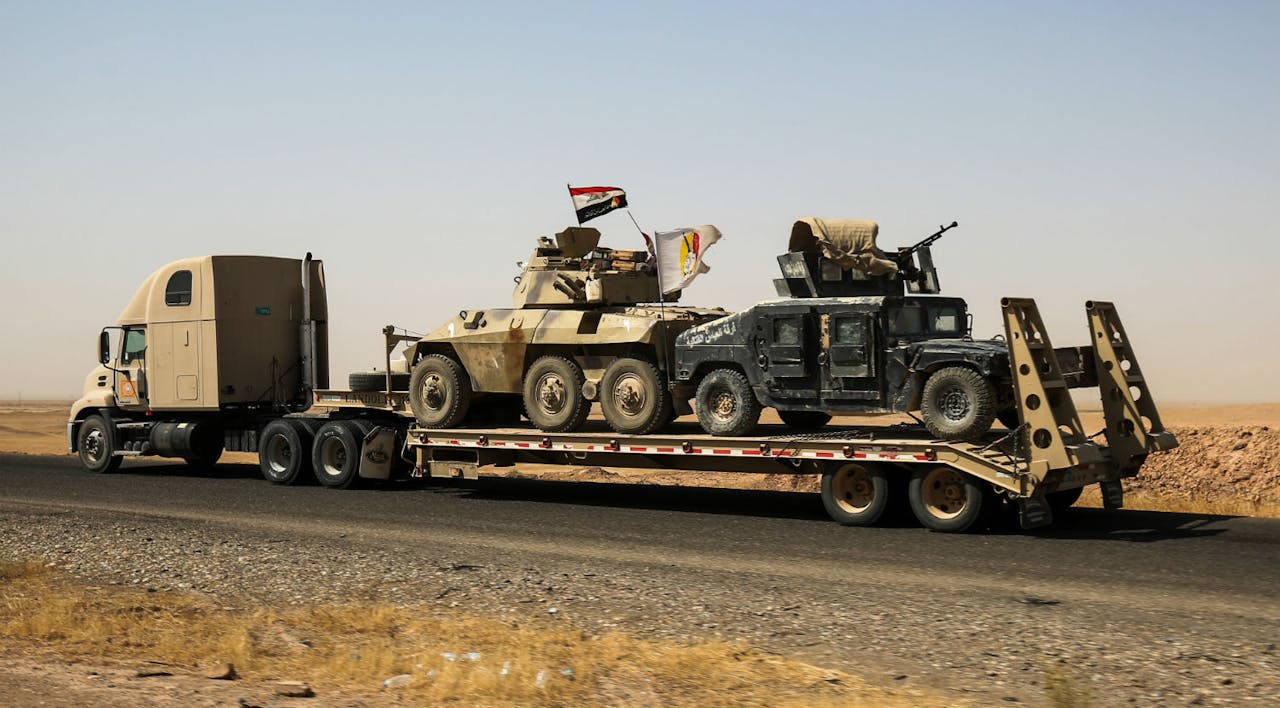 *A truck tows armored combat vehicles belonging to an Iraqi anti-Islamic State paramilitary group on August 31, 2017.* AHMAD AL-RUBAYE/AFP/Getty Images. Doran Rough Main