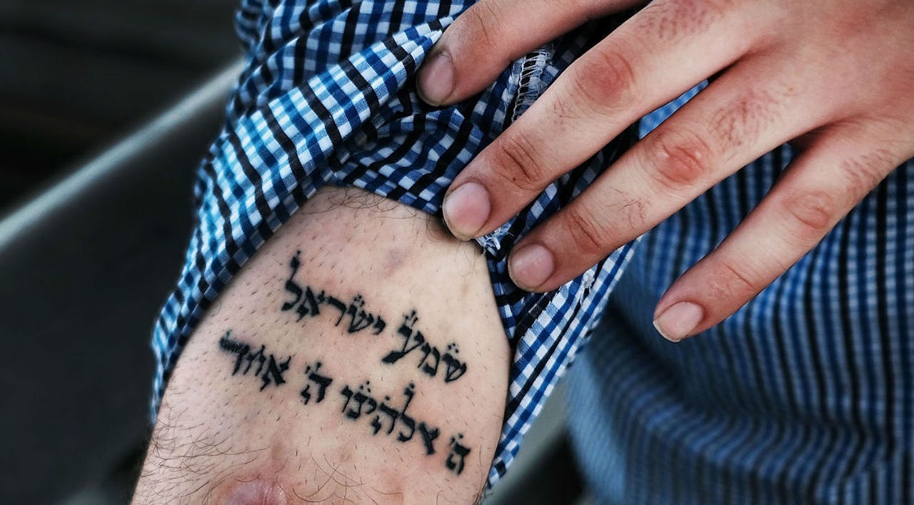 *A patient at a Brooklyn methadone clinic looks to a tattoo of the *Sh'ma* prayer in his fight with addiction.* Spencer Platt/Getty Images. Addiction Real List