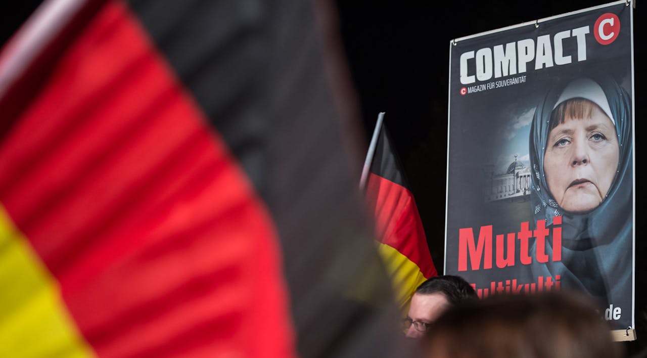 *A poster of German Chancellor Angela Merkel at a rally on November 4, 2015 in Erfurt, Germany.* Jens Schlueter/Getty Images. Merkel-Home-Main