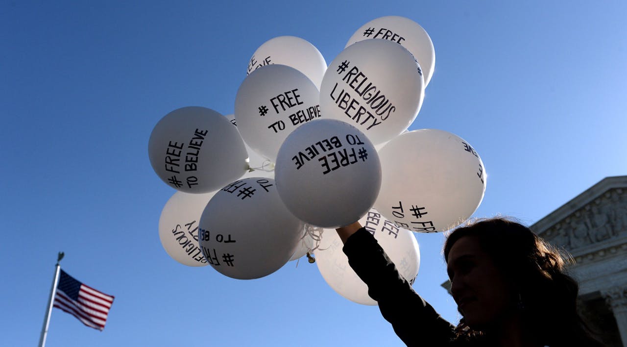 *A protestor holds balloons calling for religious freedom outside the US Supreme Court.* Olivier Douliery/Getty Images. Religious-Liberty-Main