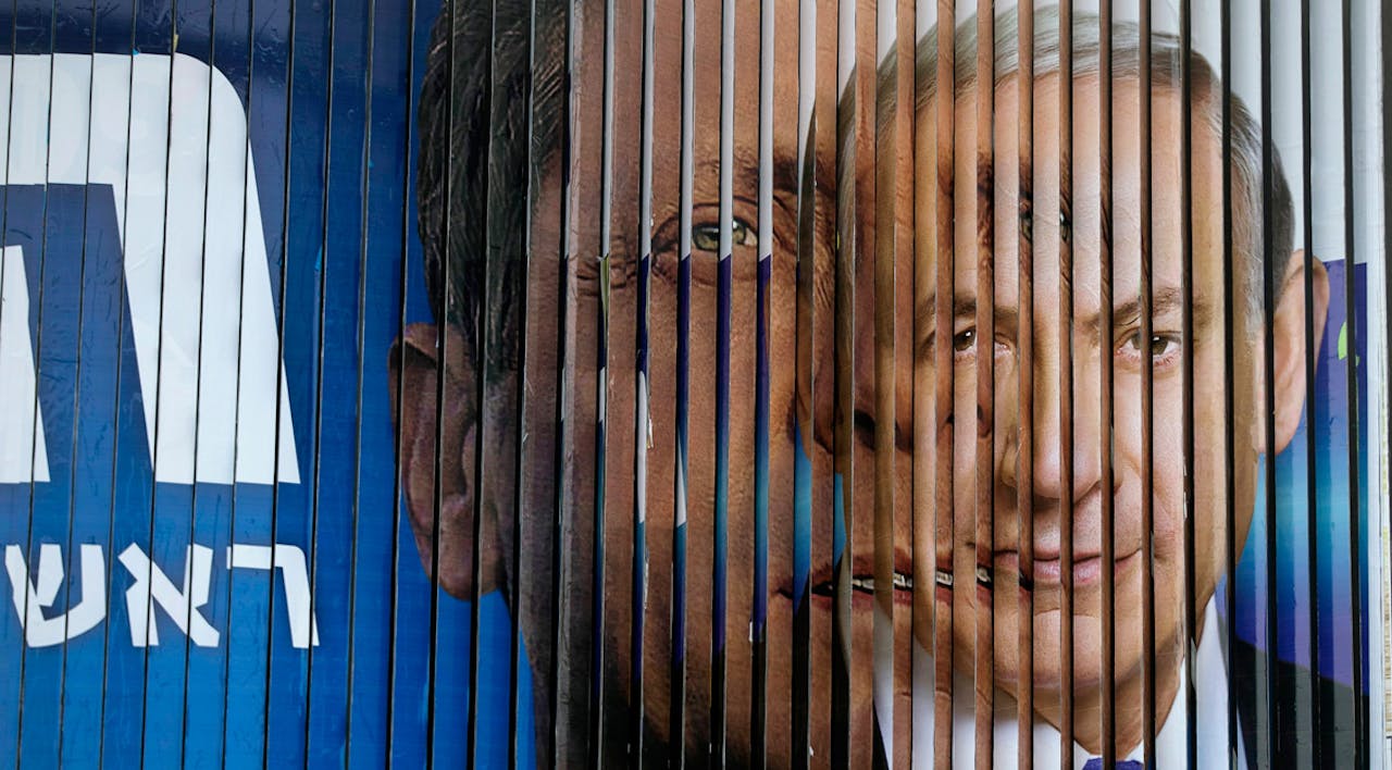 *Images of Benjamin Netanyahu and Isaac Herzog rotate on a campaign billboard in Tel Aviv on March 9, 2015.* REUTERS/Baz Ratner. Grossman-Main