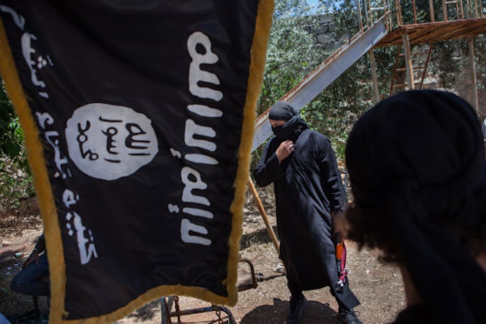 *Islamic State fighters in Aleppo, Syria on July 4, 2013.* Photo by Daniel Leal-Olivas/Corbis isfighterwithflag
