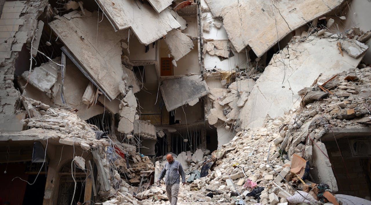 *A Syrian man walks amid destruction in the northern Syrian city of Aleppo on April 10, 2013.* © Dimitar Dilkoff/AFP/Getty Images. syriaimplosionsmall