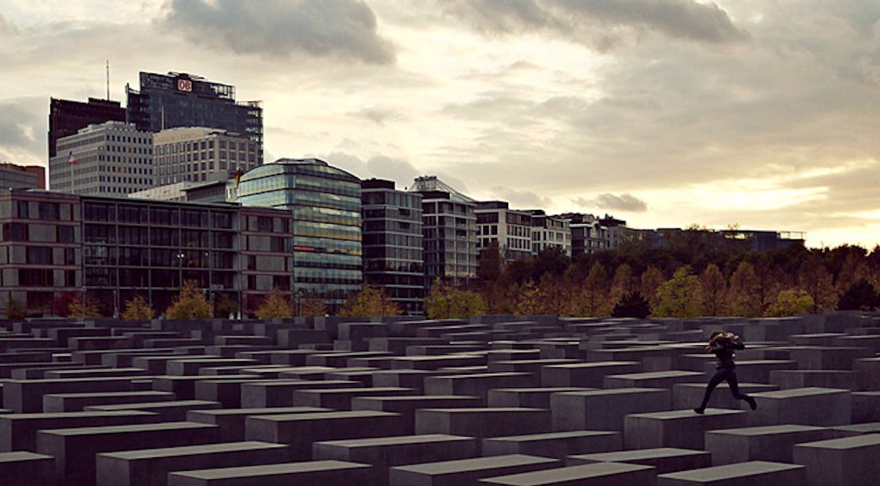 *Jumping across the Memorial to the Murdered Jews of Europe in Berlin.* Photomontage from Wikipedia. MahnmalCover